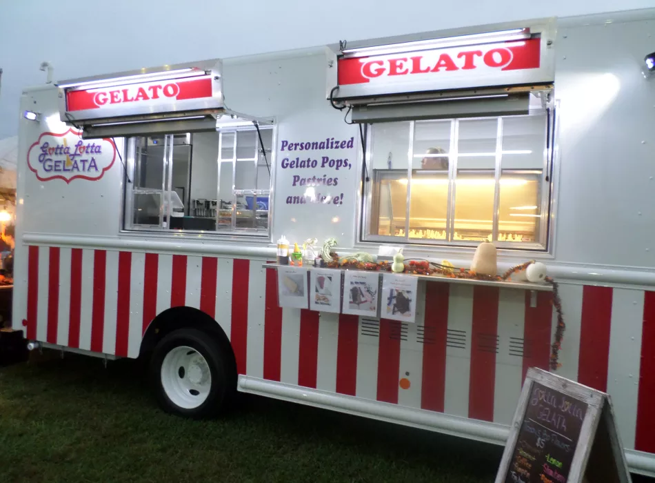 Side view of the Gotta Lotta Gelato food truck lit up at night