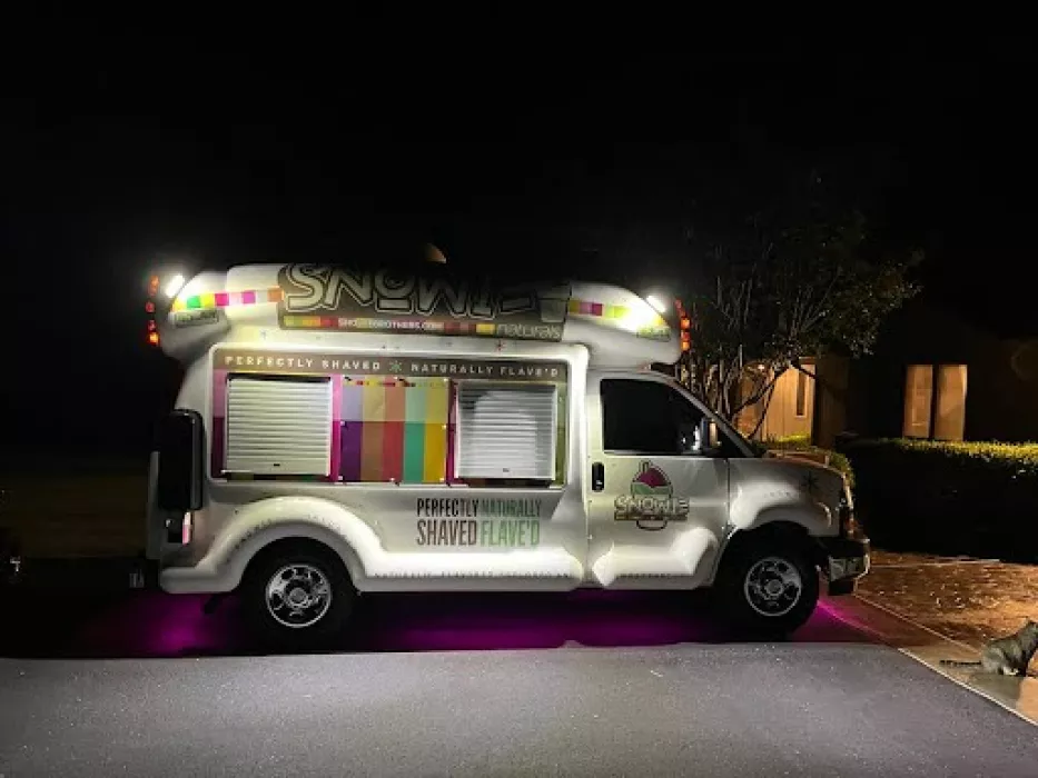 Snowie Brothers Shaved Ice Truck - A colorful, eye-catching mobile shaved ice truck serving delicious, natural, and sugar-free treats at events, fundraisers, and local festivals. The truck is fully equipped to bring refreshing shaved ice with fun, superhero-inspired flavors directly to your location. Perfect for a summer treat or any event!