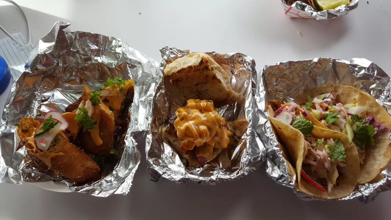 A trio of deliciousness!! Our Thai style chicken eggroll, Portuguese slider, and Fish Tacos