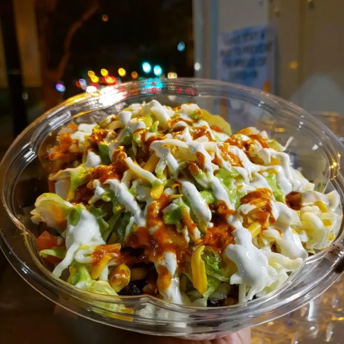 A combination of Mexican-style rice, black beans, pico de gallo, lettuce, corn, sour cream, shredded cheese (mozzarella &amp; cheddar blend), and salsa (Roja or Verde). Additionally, choose Seasoned Chicken, Spicy Chorizo, or Carne Asada.